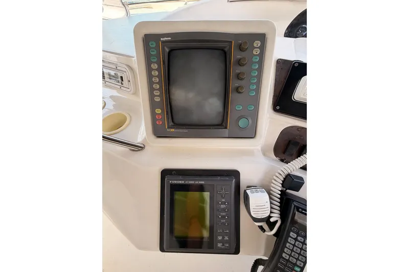 Slide: The Image of Control panel of a 1996 Sea Ray 450 Sundancer boat with navigation equipment. - 16