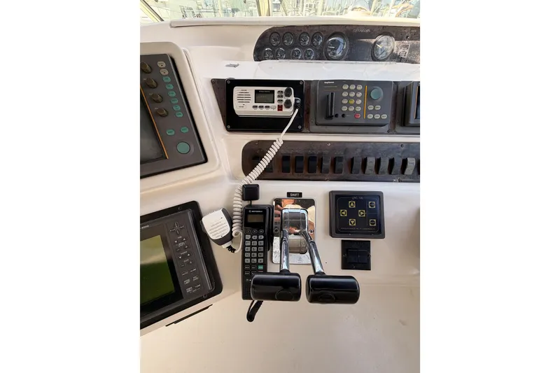 Slide: The Image of Control panel of a 1996 Sea Ray 450 Sundancer boat with navigation instruments. - 17