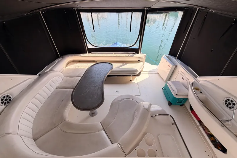 Slide: The Image of Interior of 1996 Sea Ray 450 Sundancer yacht with seating and table, overlooking water. - 23