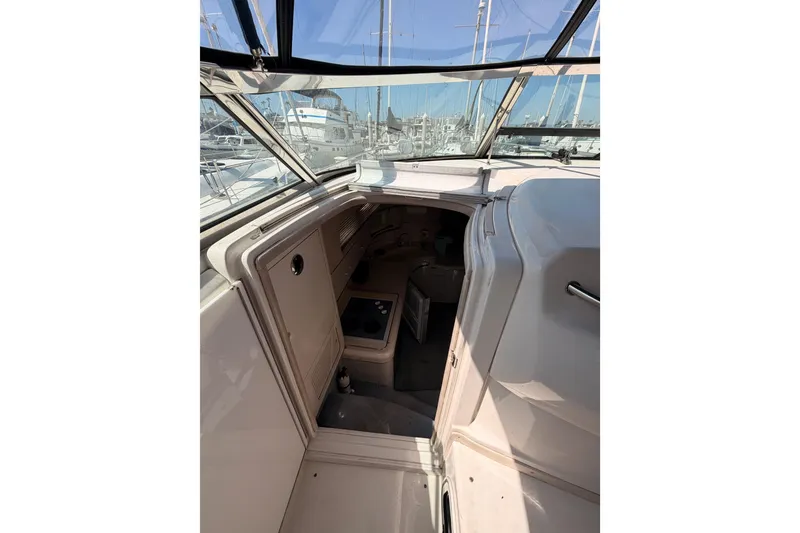 Slide: The Image of 1996 Sea Ray 450 Sundancer cabin entrance with marina view through windows. - 24