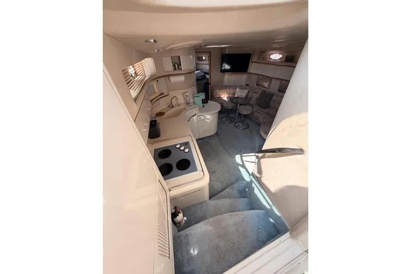 Slide: The Image of Interior of 1996 Sea Ray 450 Sundancer yacht with kitchen and seating area. - 26