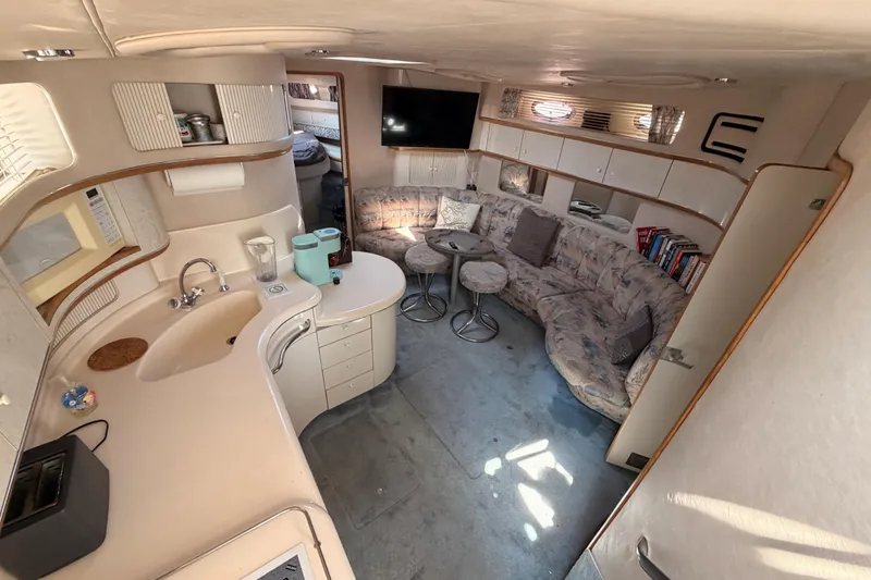 Slide: The Image of Interior of 1996 Sea Ray 450 Sundancer yacht with kitchen and cozy seating area. - 27