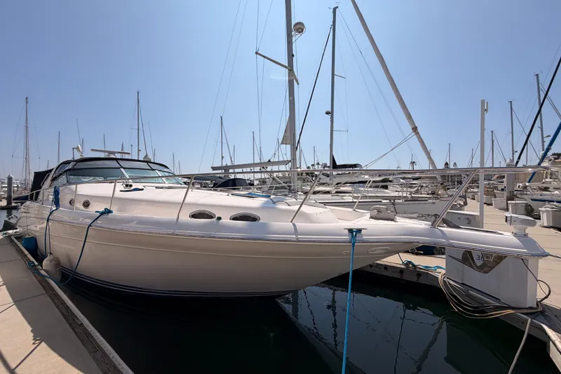 Slide: The Image of 1996 Sea Ray 450 Sundancer yacht docked at marina under clear blue sky. - 3