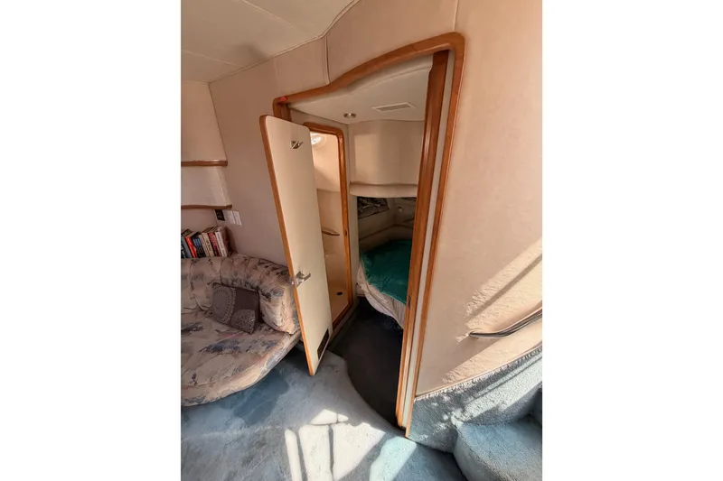 Slide: The Image of Interior of 1996 Sea Ray 450 Sundancer yacht, featuring cozy cabin and seating area. - 33