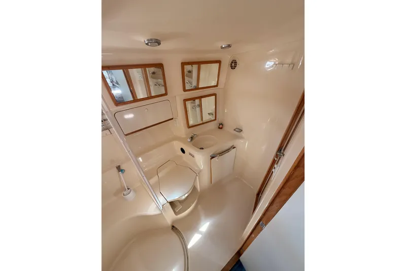 Slide: The Image of Bathroom interior of 1996 Sea Ray 450 Sundancer yacht, featuring mirrors and sink. - 39