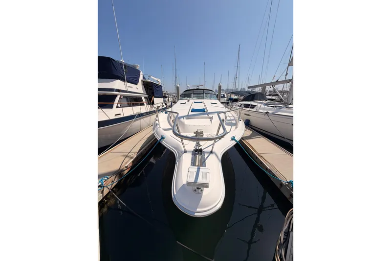 Slide: The Image of 1996 Sea Ray 450 Sundancer yacht docked at marina, surrounded by other boats. - 4