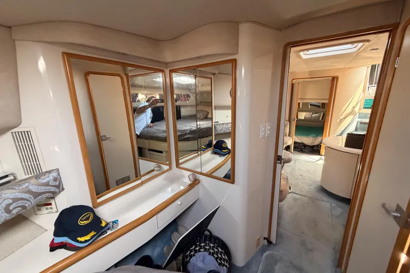 Slide: The Image of Interior of 1996 Sea Ray 450 Sundancer yacht, featuring mirrors and cozy cabin spaces. - 45