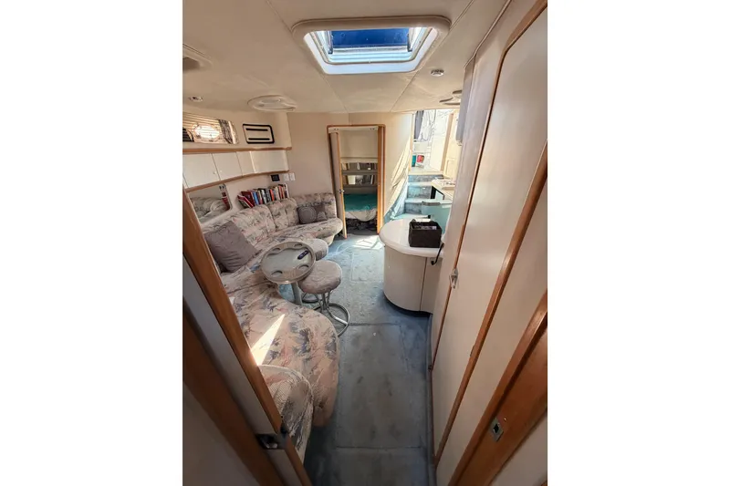 Slide: The Image of Interior of 1996 Sea Ray 450 Sundancer yacht, featuring cozy seating and natural light. - 47