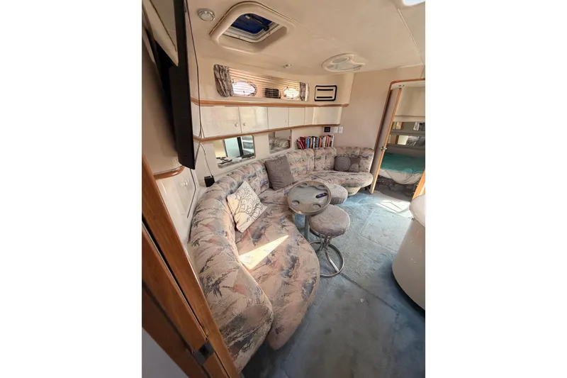 Slide: The Image of Interior of 1996 Sea Ray 450 Sundancer yacht with plush seating and modern decor. - 48