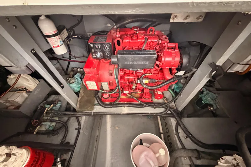 Slide: The Image of Engine compartment of a 1996 Sea Ray 450 Sundancer with red machinery and fire extinguisher. - 52