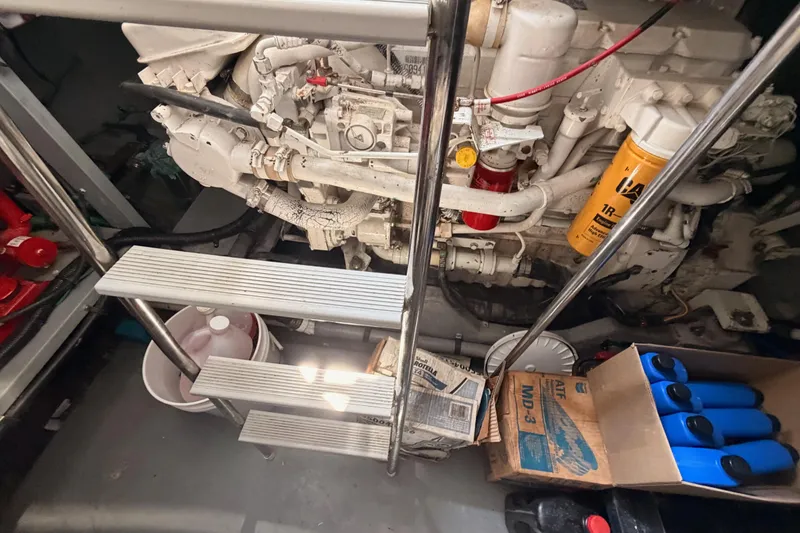 Slide: The Image of Engine room of a 1996 Sea Ray 450 Sundancer with visible maintenance supplies. - 54