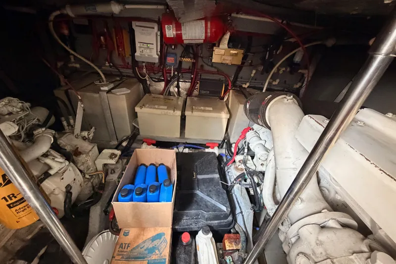 Slide: The Image of Engine room of a 1996 Sea Ray 450 Sundancer with batteries and maintenance supplies. - 55