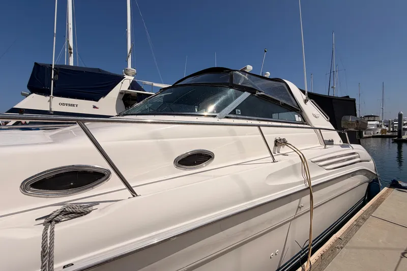 Slide: The Image of 1996 Sea Ray 450 Sundancer yacht docked at marina under clear blue sky. - 6
