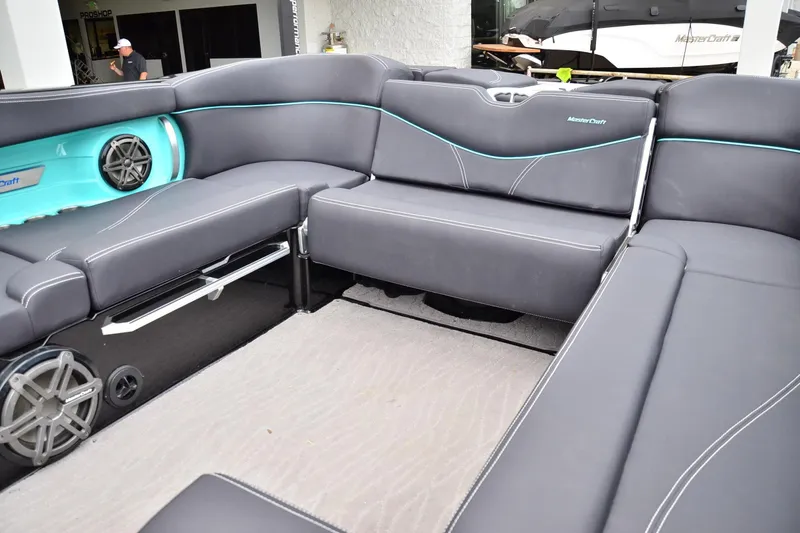 Slide: The Image of 2017 MasterCraft X26 boat interior with gray seating and teal accents. - 12