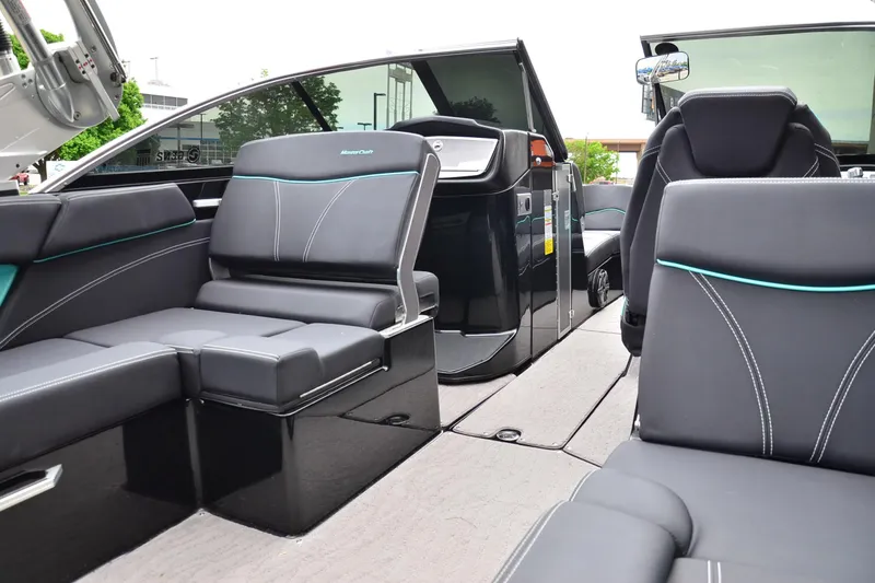 Slide: The Image of 2017 MasterCraft X26 boat interior with sleek black seating and modern design. - 14