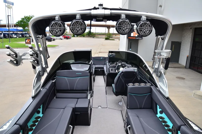 Slide: The Image of 2017 MasterCraft X26 boat interior with sleek seating and advanced audio system. - 16