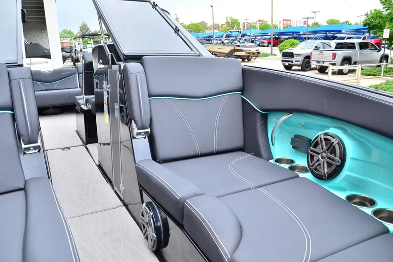 Slide: The Image of 2017 MasterCraft X26 boat interior with sleek seating and modern audio system. - 8