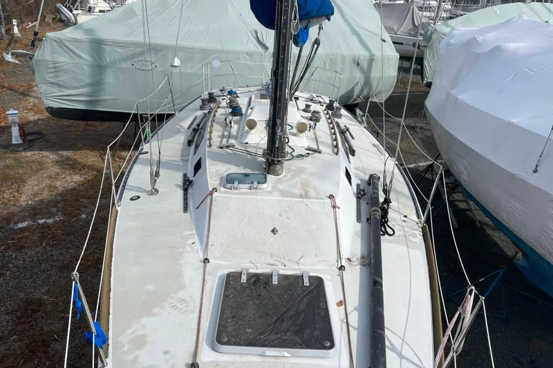 Slide: The Image of 1986 Alsberg Brothers Express 37 sailboat on land, covered and stored. - 10