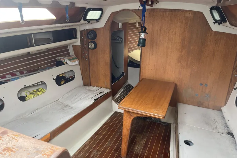 Slide: The Image of Interior of 1986 Alsberg Brothers Express 37 sailboat with wooden table and seating. - 14