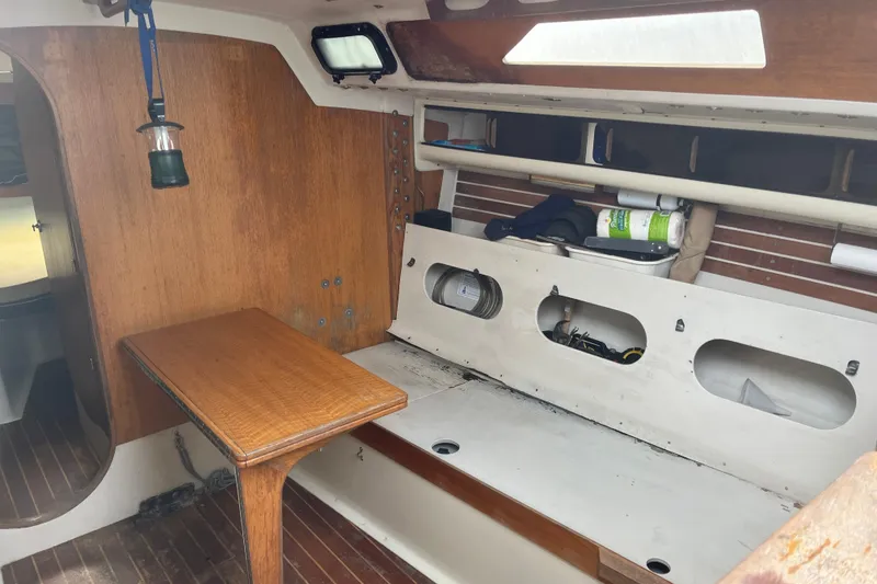 Slide: The Image of Interior of 1986 Alsberg Brothers Express 37 sailboat with wooden table and storage compartments. - 15