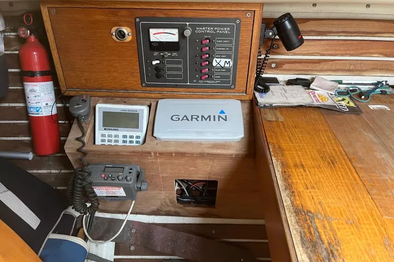 Slide: The Image of Control panel and navigation equipment inside a 1986 Alsberg Brothers Express 37 sailboat. - 23