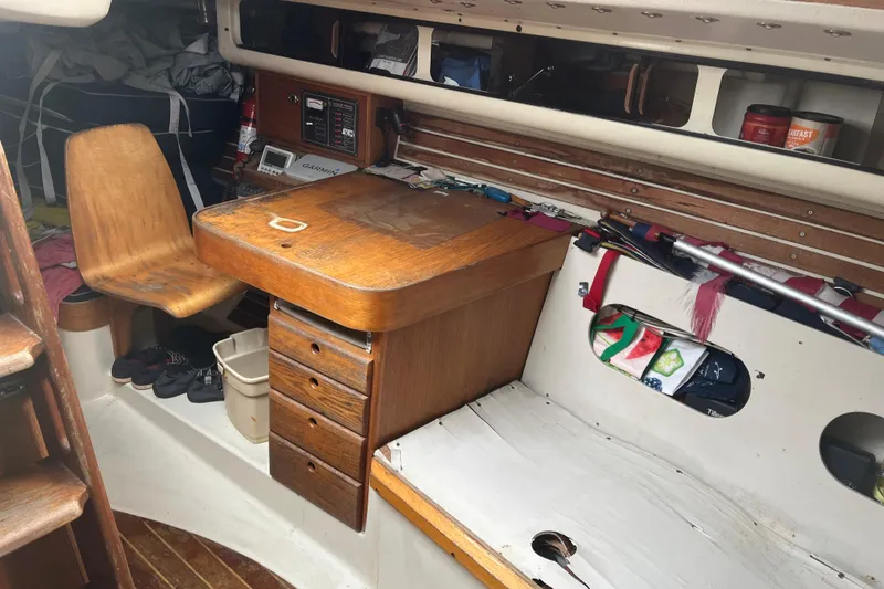 Slide: The Image of Interior of 1986 Alsberg Brothers Express 37 sailboat with navigation station and wooden chair. - 25