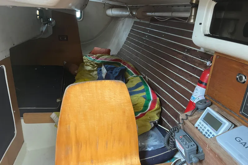 Slide: The Image of Interior of 1986 Alsberg Brothers Express 37 sailboat with wooden paneling and navigation equipment. - 26
