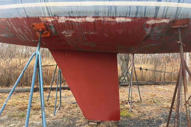 Slide: The Image of 1986 Alsberg Brothers Express 37 sailboat keel on stands, showing weathered hull. - 28