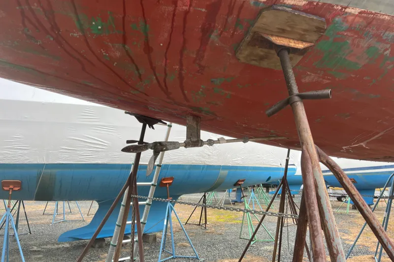 Slide: The Image of 1986 Alsberg Brothers Express 37 sailboat under maintenance, supported by stands. - 29