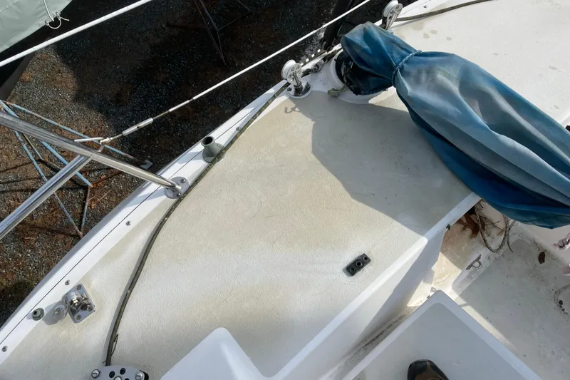 Slide: The Image of Deck view of a 1986 Alsberg Brothers Express 37 sailboat, featuring rigging and covered equipment. - 34