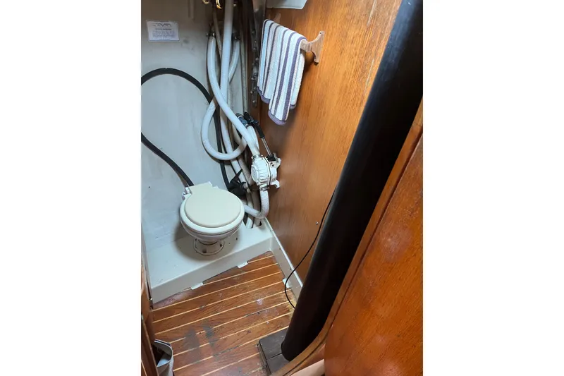 Slide: The Image of 1986 Alsberg Brothers Express 37 yacht bathroom with wooden flooring and marine toilet. - 43