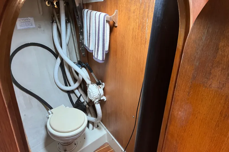 Slide: The Image of Compact marine toilet in 1986 Alsberg Brothers Express 37 sailboat bathroom. - 44