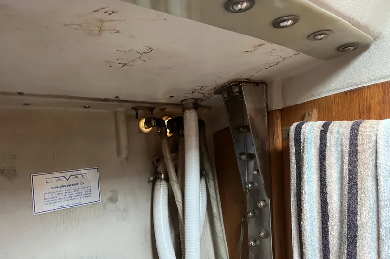 Slide: The Image of Interior of 1986 Alsberg Brothers Express 37 showing plumbing and striped towel. - 45