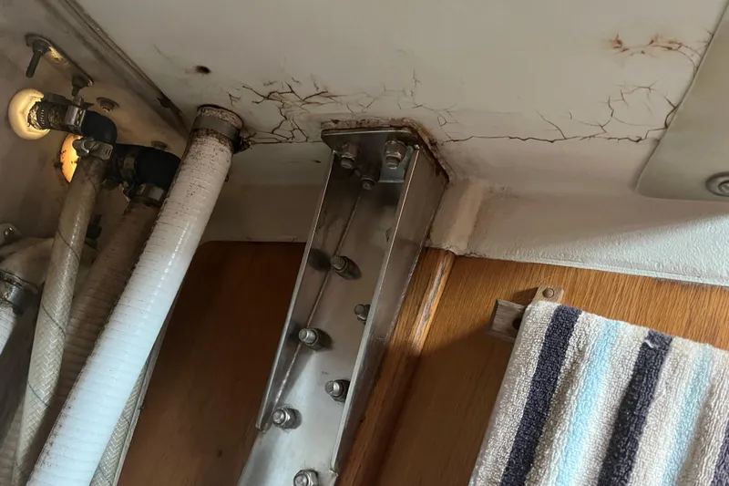 Slide: The Image of Interior view of 1986 Alsberg Brothers Express 37 showing structural cracks and plumbing. - 46