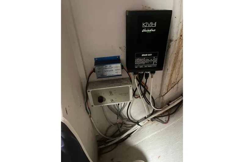 Slide: The Image of Electrical components inside a 1986 Alsberg Brothers Express 37 yacht, featuring wiring and control boxes. - 47