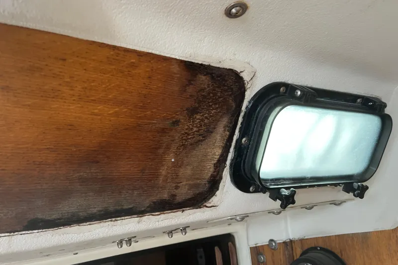 Slide: The Image of Interior of 1986 Alsberg Brothers Express 37 showing wood paneling and a window. - 52