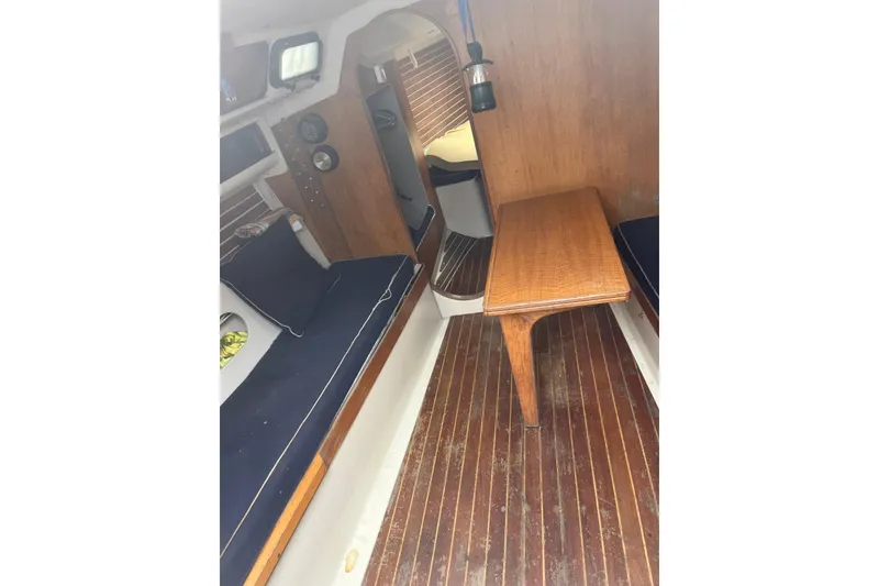 Slide: The Image of Interior of 1986 Alsberg Brothers Express 37 sailboat with wooden flooring and seating. - 55