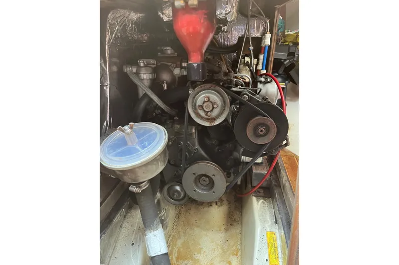 Slide: The Image of Engine compartment of a 1986 Alsberg Brothers Express 37 sailboat, showcasing belts and components. - 58