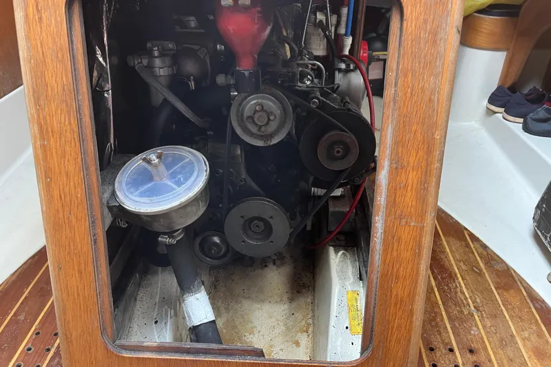 Slide: The Image of Engine compartment of a 1986 Alsberg Brothers Express 37 sailboat, showcasing mechanical components. - 59