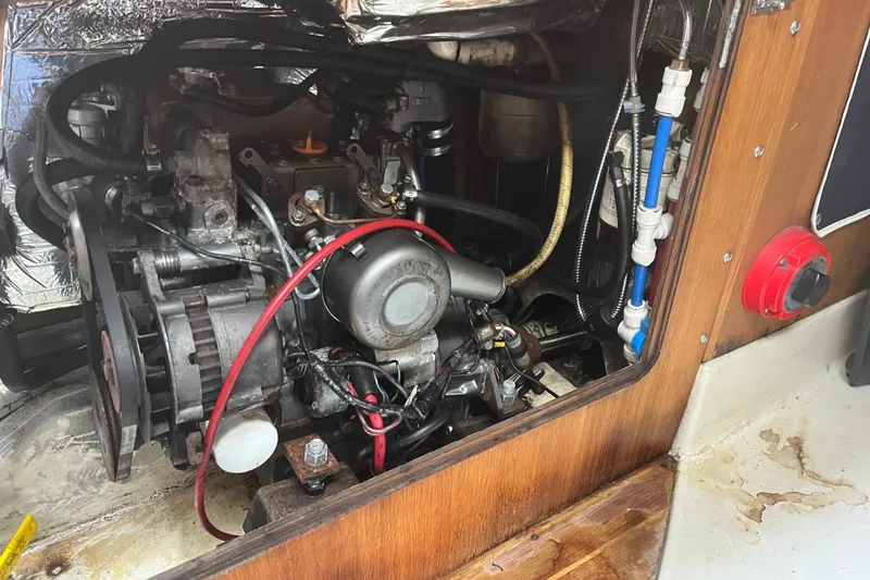 Slide: The Image of Engine compartment of a 1986 Alsberg Brothers Express 37 sailboat, showcasing mechanical components. - 60