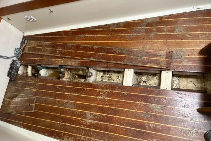 Slide: The Image of Wooden floorboards of a 1986 Alsberg Brothers Express 37, partially removed, revealing structural components. - 62