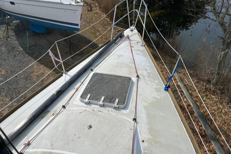 Slide: The Image of Bow view of 1986 Alsberg Brothers Express 37 sailboat, docked near water. - 9