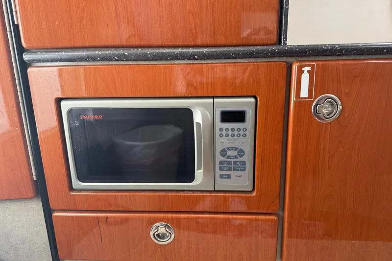 Slide: The Image of Built-in microwave in 2007 Formula 330 Sun Sport boat kitchen area. - 10