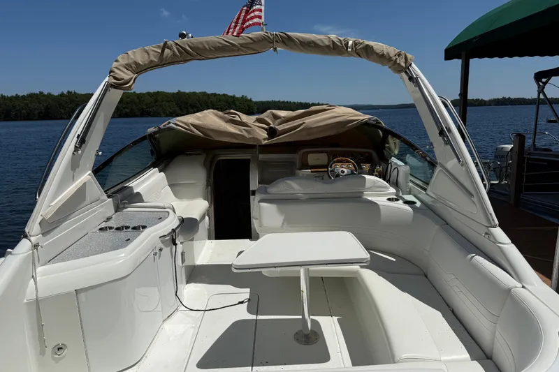 Slide: The Image of 2007 Formula 330 Sun Sport boat interior with seating and table on a serene lake. - 4