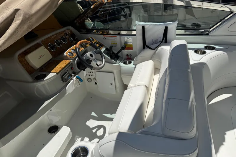 Slide: The Image of 2007 Formula 330 Sun Sport boat interior with white seating and wood-accented dashboard. - 6