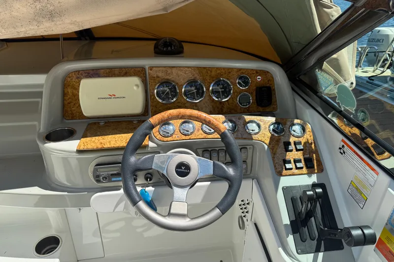 Slide: The Image of 2007 Formula 330 Sun Sport boat dashboard with steering wheel and instrument panel. - 8