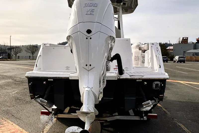 Slide: The Image of 2025 Solara S-250 CW boat with powerful outboard motor in a parking area. - 11