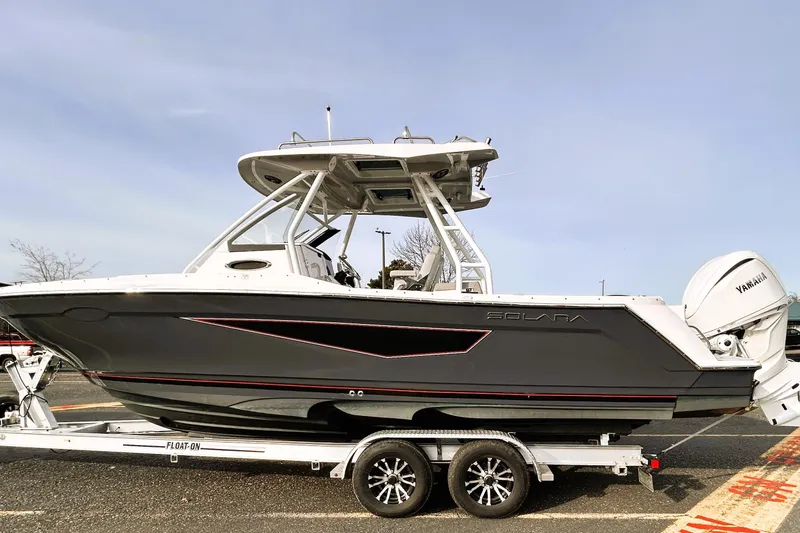 Slide: The Image of 2025 Solara S-250 CW boat on trailer, featuring sleek design and Yamaha engine. - 13