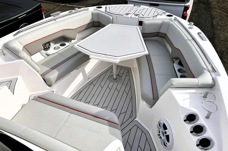 Slide: The Image of Luxurious seating area on 2025 Solara S-250 CW boat with table and cup holders. - 24