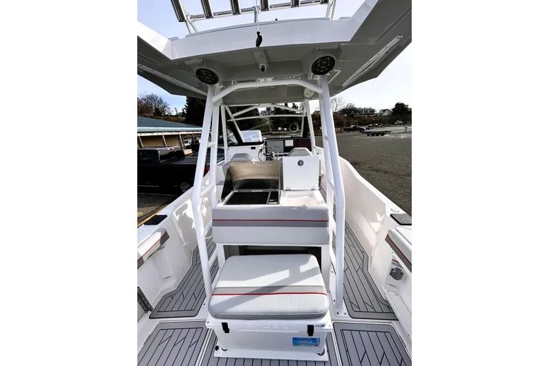 Slide: The Image of 2025 Solara S-250 CW boat interior with seating and helm, docked outdoors. - 28